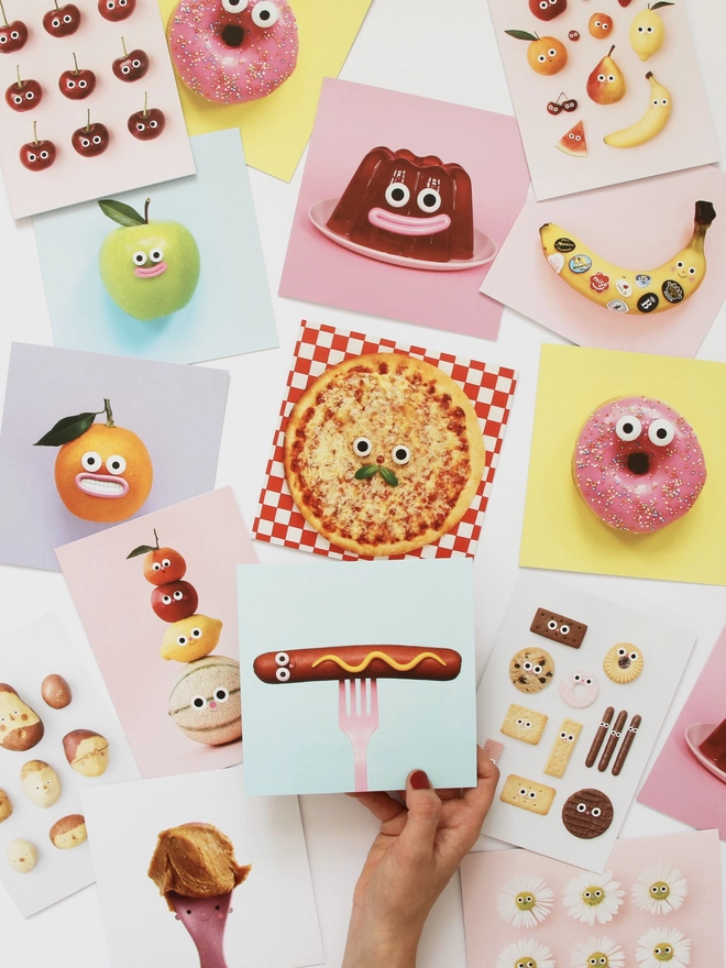 A selection of colourful cards with food with faces. 