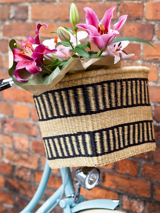 black and natural bike basket styled with flowers