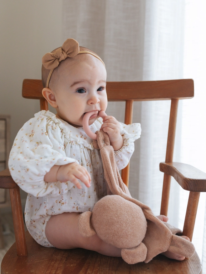 Baby with teething teddy toy