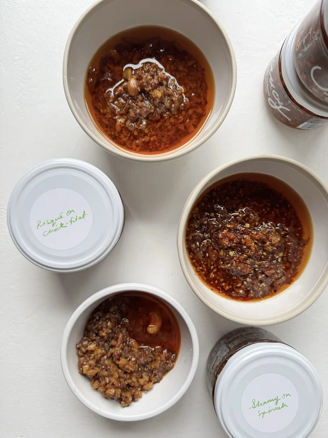 The Extra Saucy Collection (Set Of 6), a collection of some bowls and sauces sitting on a white table surface. 