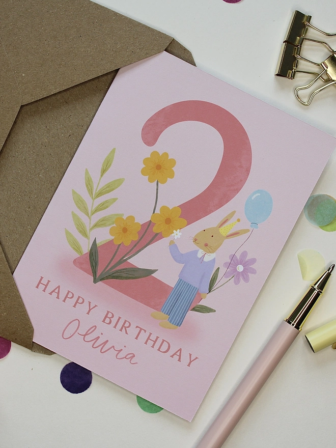 personalised floral 2nd birthday card. pink 2nd birthday card with illustrated rabbit and flowers.