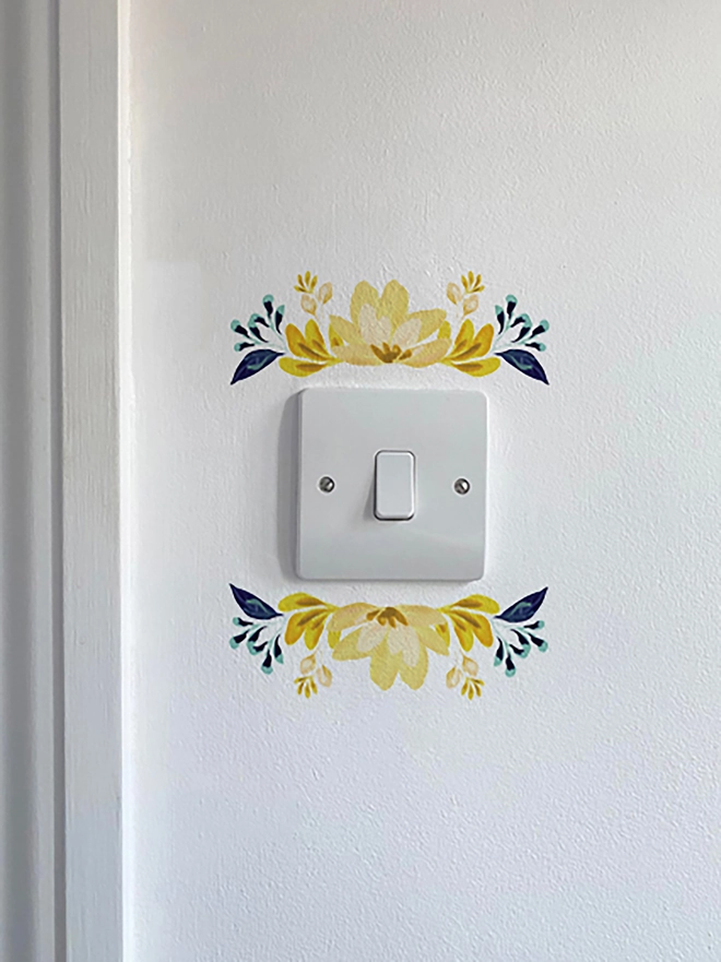 Light switch floral wall sticker, flower detail above and below light switch, handpaitnted floral design in shades of yellow