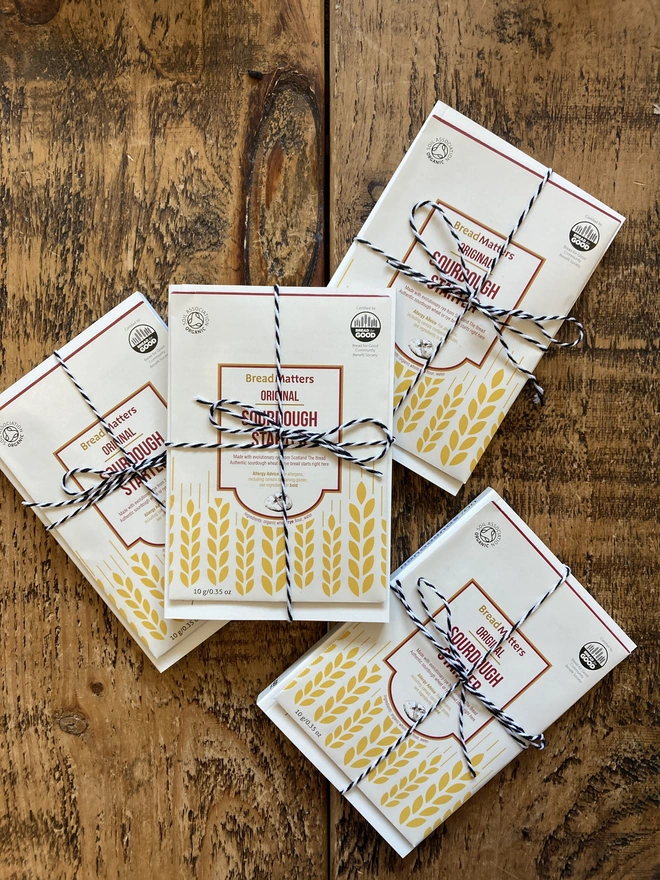 4 sourdough book and starter kits wrapped in twine