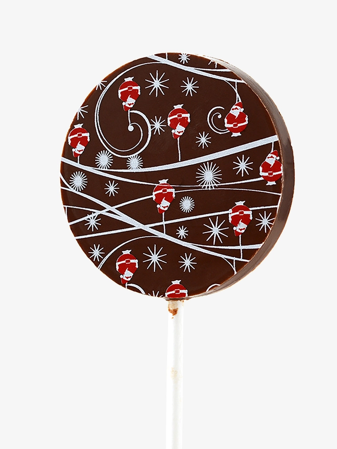 A dark chocolate lollipop with a festive Christmas design