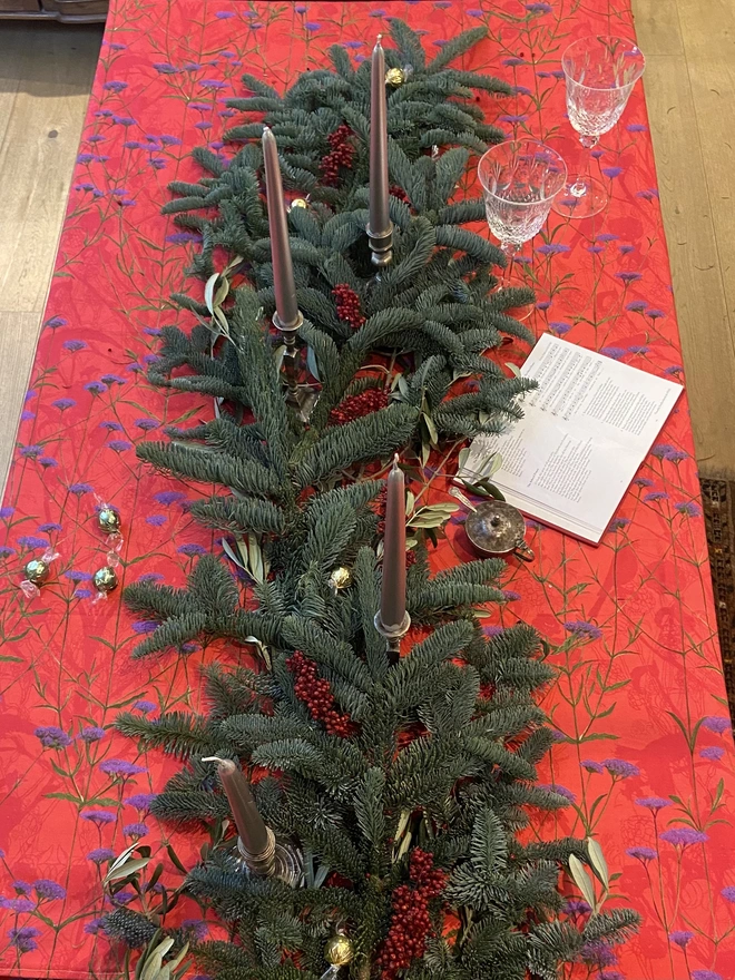 A rich pink floral tablecloth, perfect for summer or winter entertaining