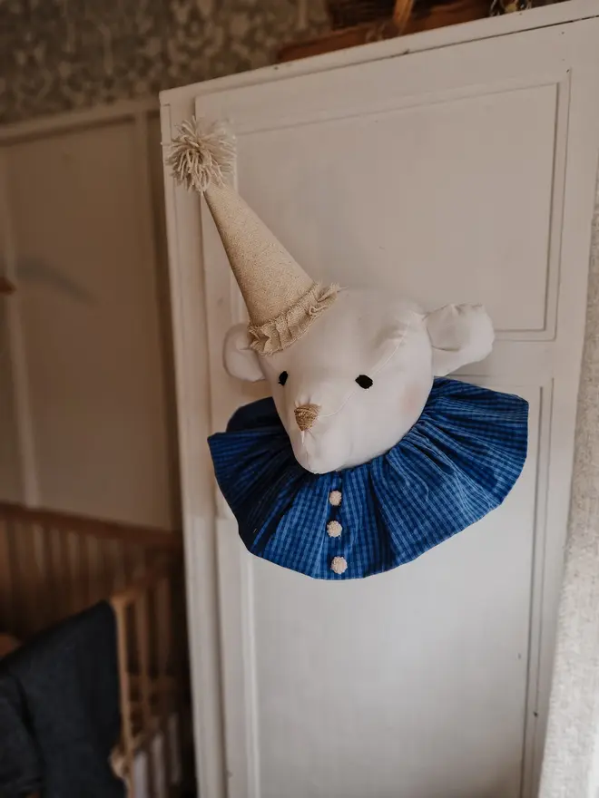 Bear Head Nursery Decoration, a bear decoration sitting against a wall in a child's decorated bedroom. 
