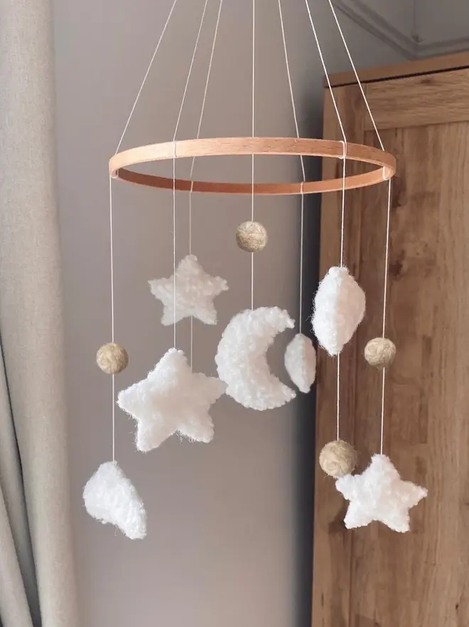 'sweet dreams' boucle baby mobile. a baby mobile hanging from the ceiling with moons, stars and clouds.