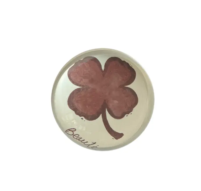 Burgundy clover
paperweights on a white background. 