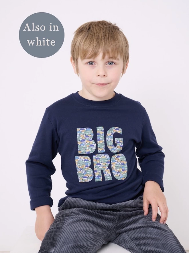 Big Bro appliquéd in a vintage cars Liberty print on a navy cotton long sleeve t-shirt. Worn by a smiling 5 year old boy.