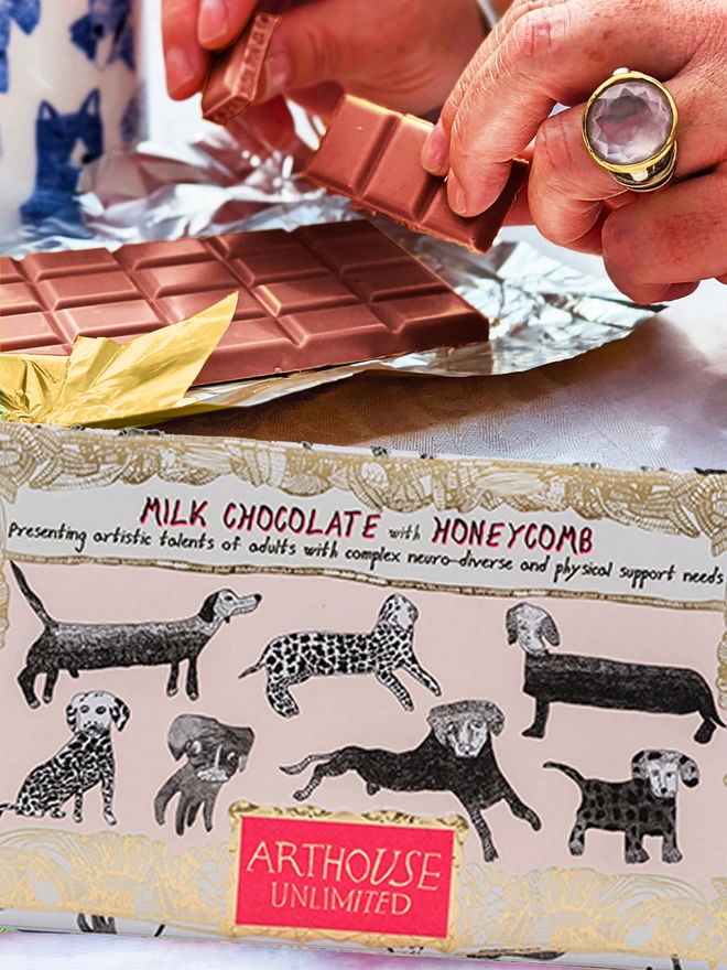 Charity milk chocolate with honeycomb pieces packaged in gold foil card decorated with hand drawn dogs 