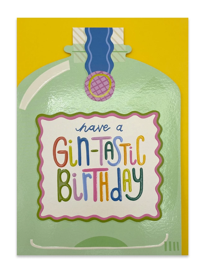 The vibrant Raspberry Blossom ‘Have a gin-tastic birthday’ card sits on a sunshine yellow envelope
