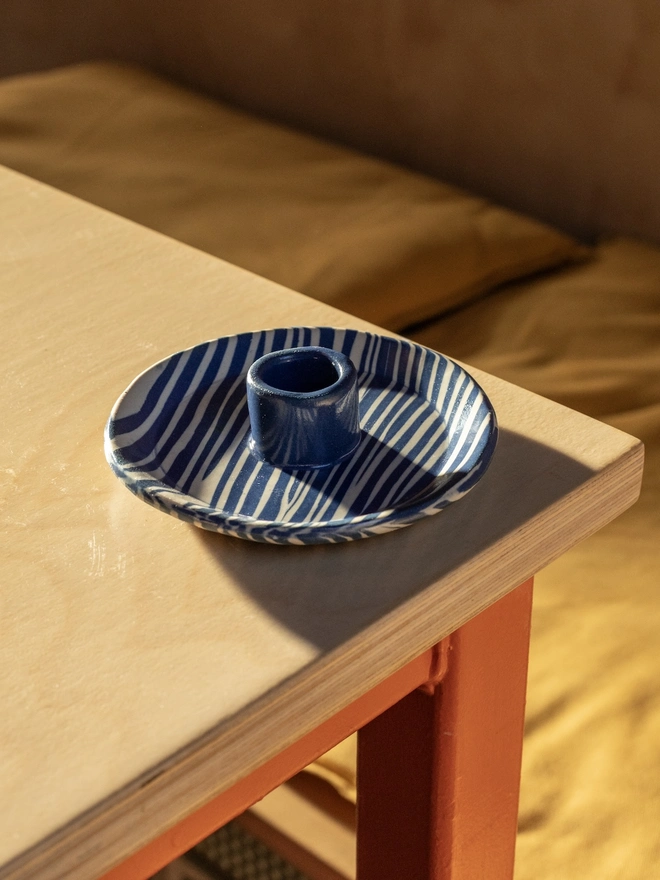 Ceramic Patterned Candlestick Holder, a colourful candlestick holder sitting on a table top surface. 
