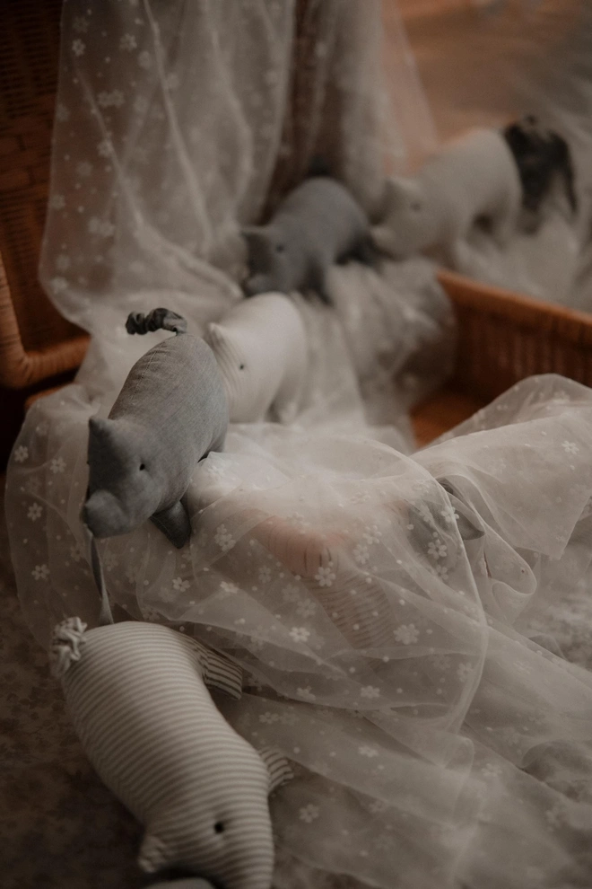 Pig Garland Decoration, a grey and white pig garland decoration in a child's bedroom. It is accompanied by other bedroom accessories. 