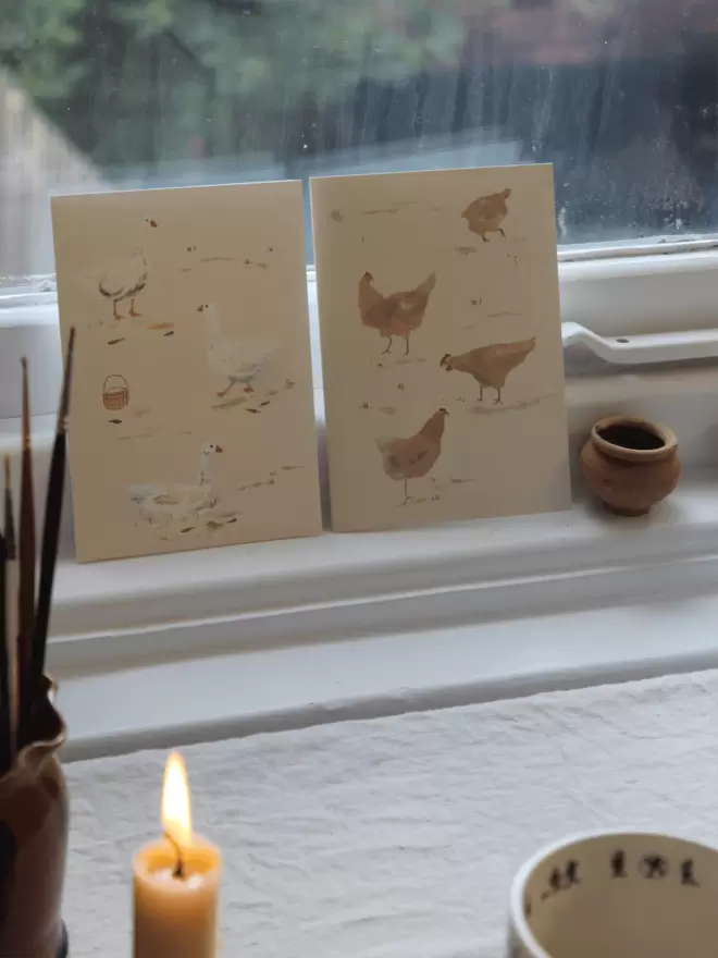 2 illustrated cards with geese and chickens 