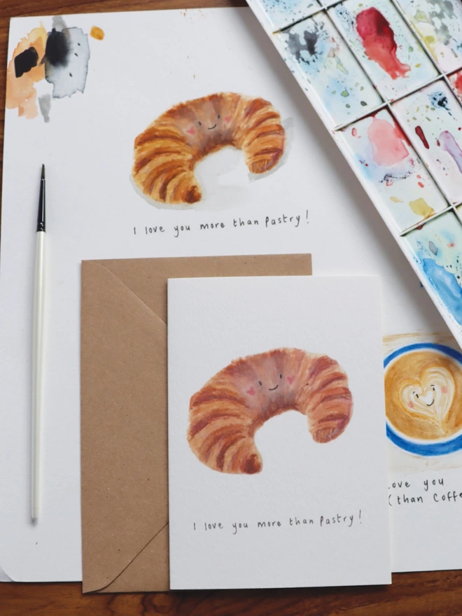 I love you more than Pastry Greeting Card.  Illustrated Croissant with a smiley face Valentines Card 
