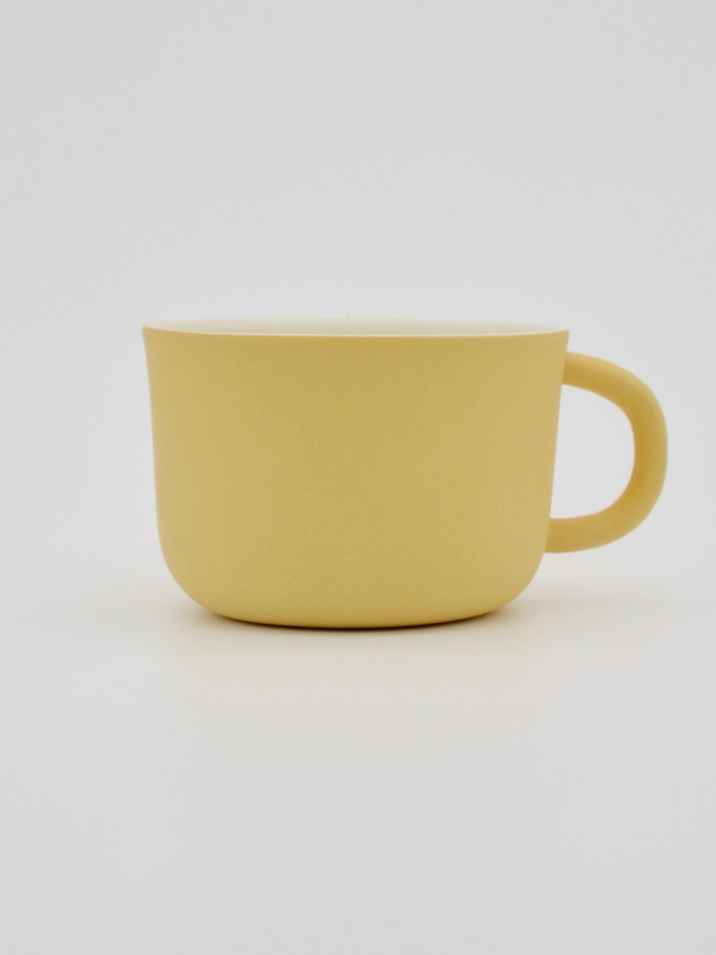 Handmade Porcelain Coffee Cup. A yellow coffee cup.