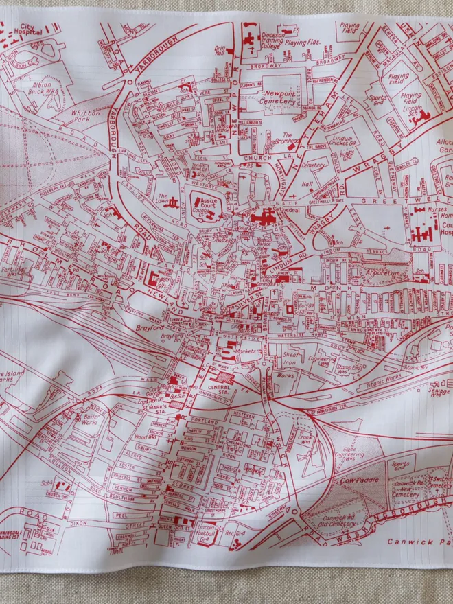 Mr.PS Lincoln Map Handkerchief screenprinted in red, laid on a linen tablecloth