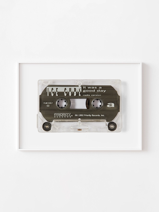 ice cube it was a good day cassette tape print. framed print hung on white wall.
