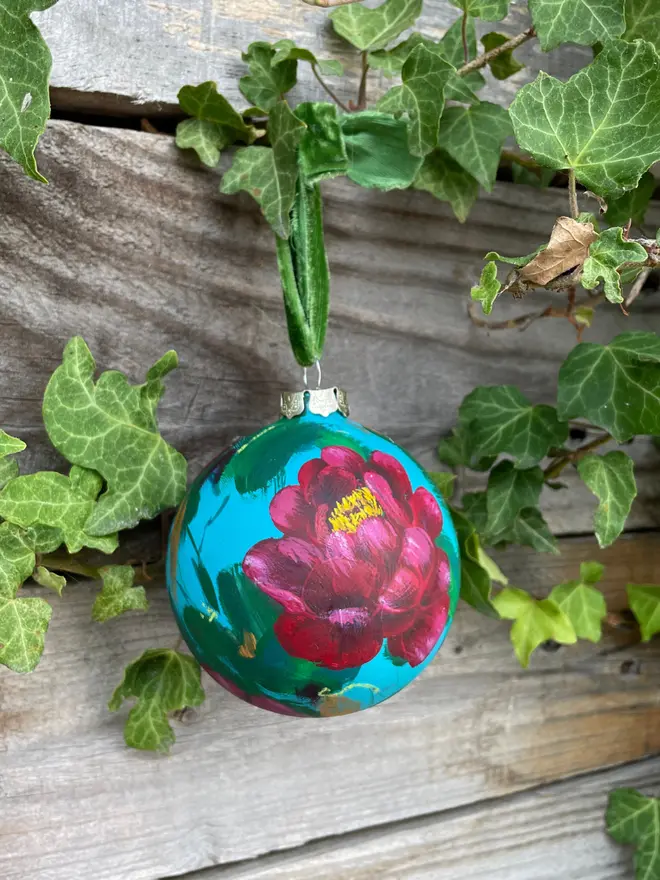 hand painted ceramic floral bauble background painted in a turquoise adorned in rich deep red peony flowers