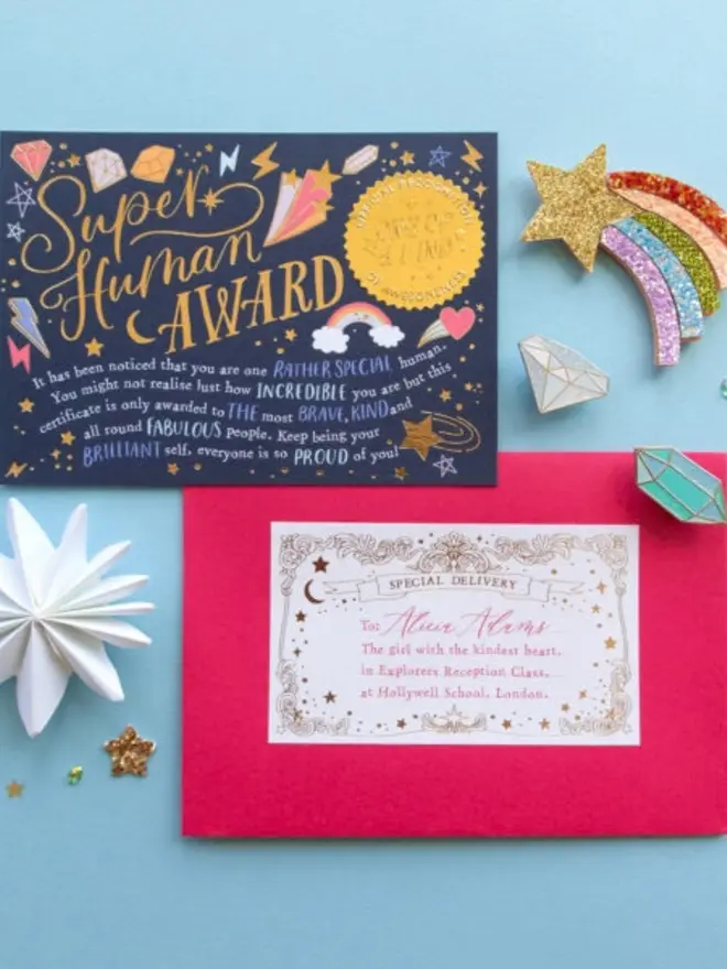 The navy certificate praising a "rather special human" sits above a pink envelope. The envelope's "Special Delivery" label is addressed to Alicia Adams, "the girl with the kindest heart."