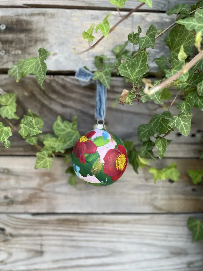  Unique hand-painted large ceramic floral Christmas bauble featuring red yuletide camellia flowers on a pale pink background