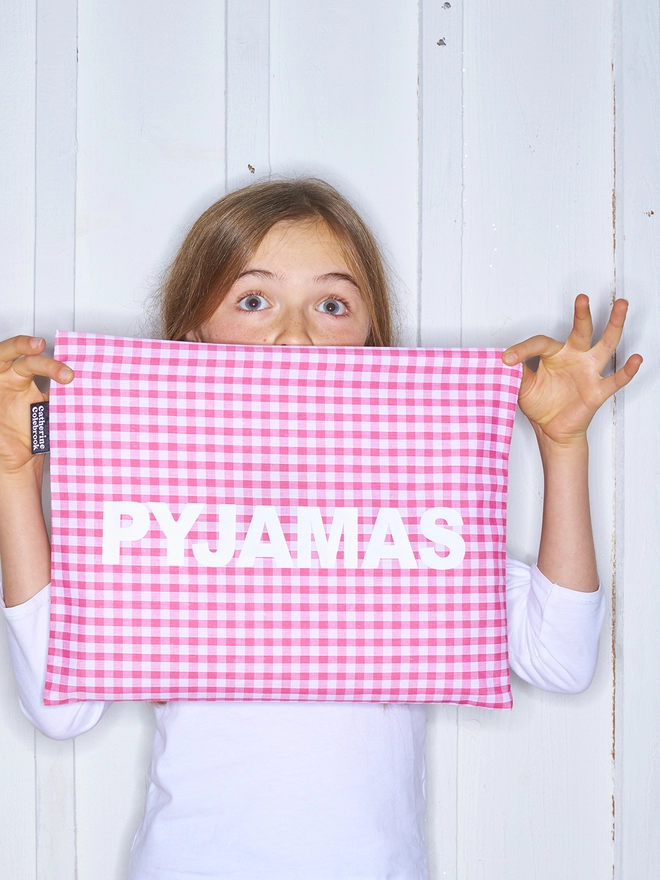 Pink gingham pyjama case with white writing
