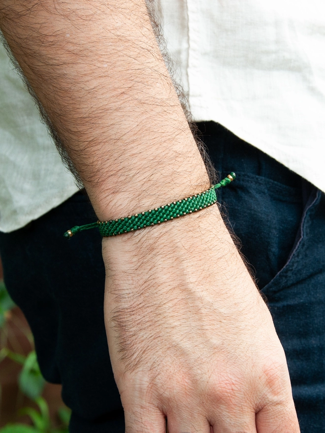 green rope and bronze bracelet