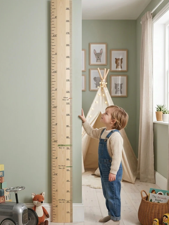 Raw Redwood Ruler Height Chart. A wooden height chart leaning on a child’s wall.
