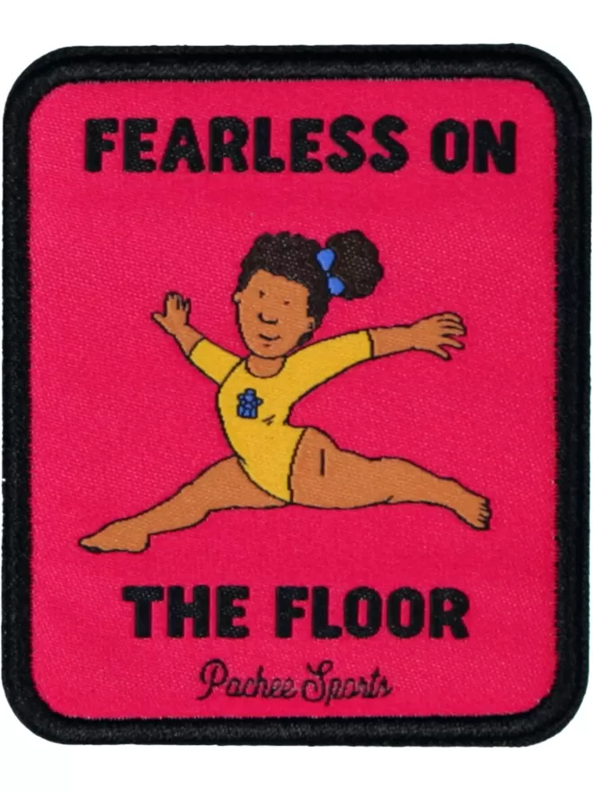 Pink and black patch with a leaping gymnast in the centre. 'Fearless on the floor, Pachee Sports' embroidered around the figure.