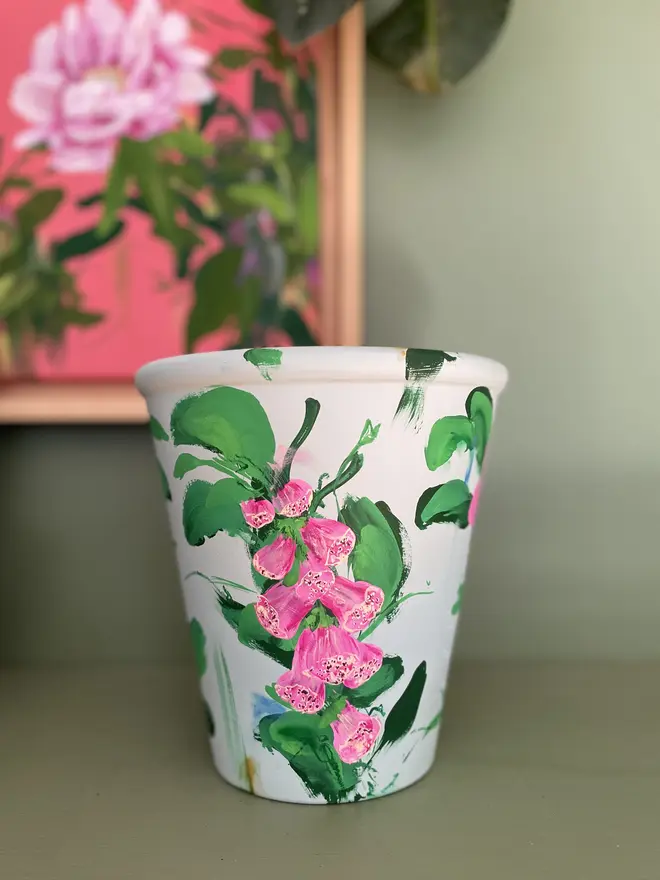 hand painted terracotta floral fox glove plant pot background in a light mint with pink fox glove flowers