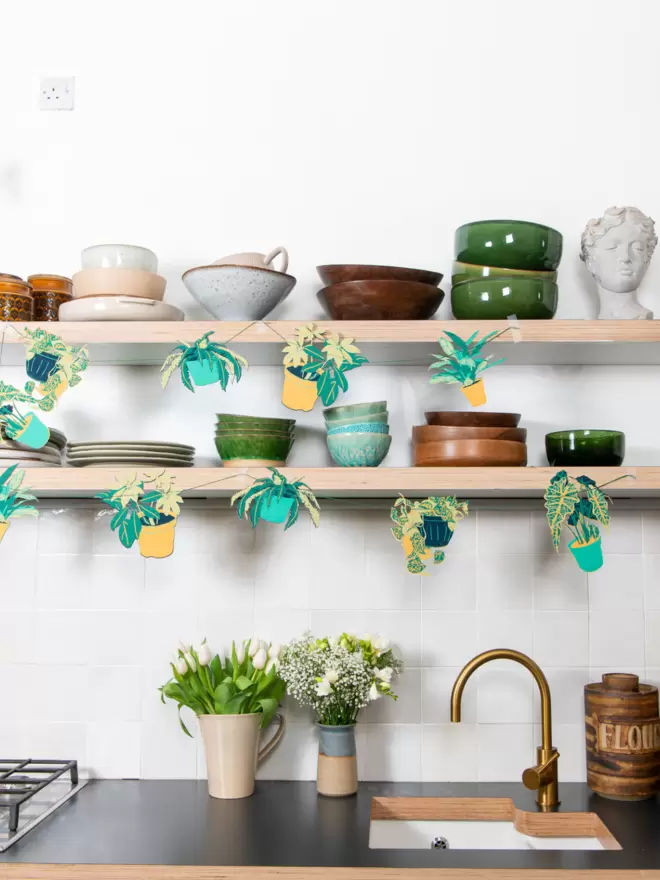 garland hanging in the kitchen along some shelves