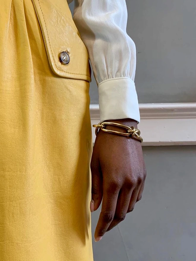A model wearing a contemporary heavy gold chain bracelet