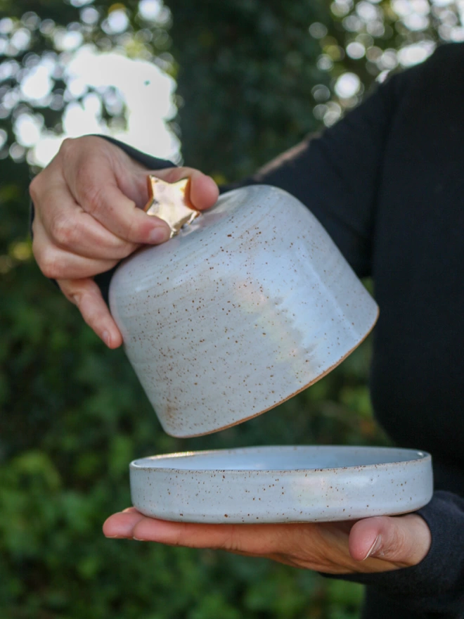 holding the butter dish