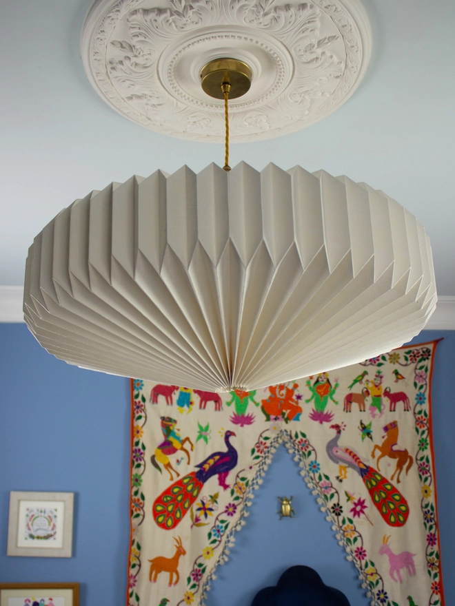 White origami lightshade hanging from ceiling 