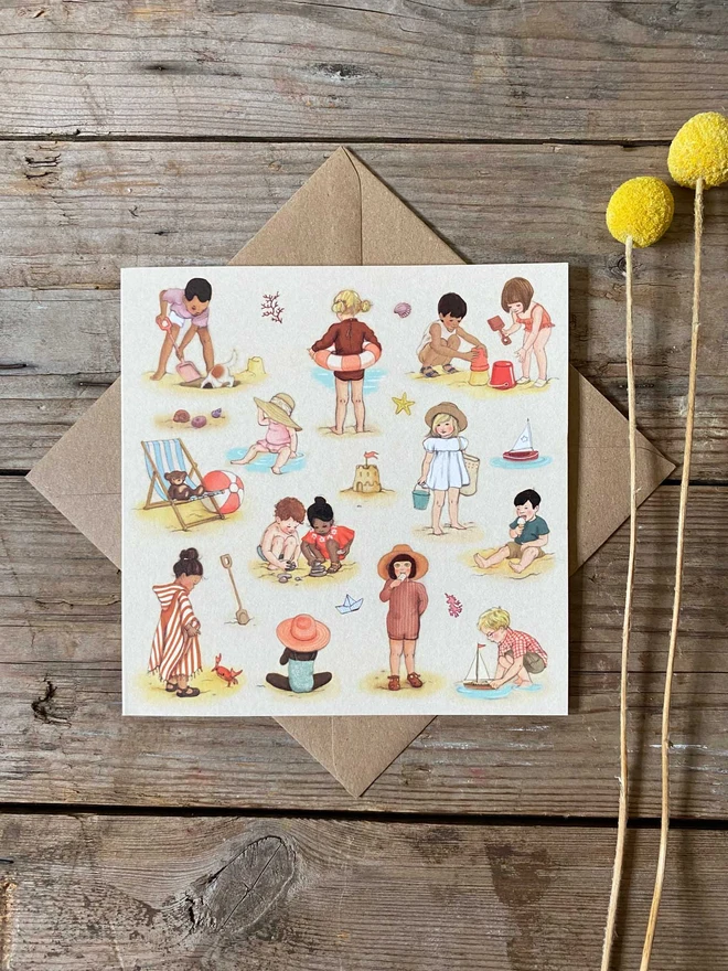 vintage story book style illustrated summer greeting card featuring young children having fun on the beach