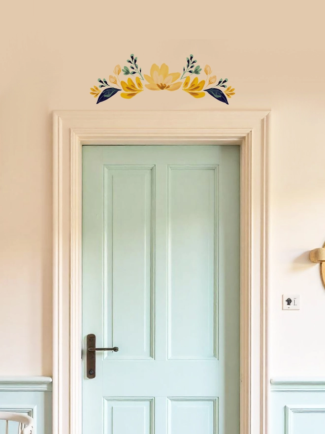 Internal door with an elegant floral wall sticker  / decal positioned above the door in different shades of yellow, handpainted floral wall sticker 