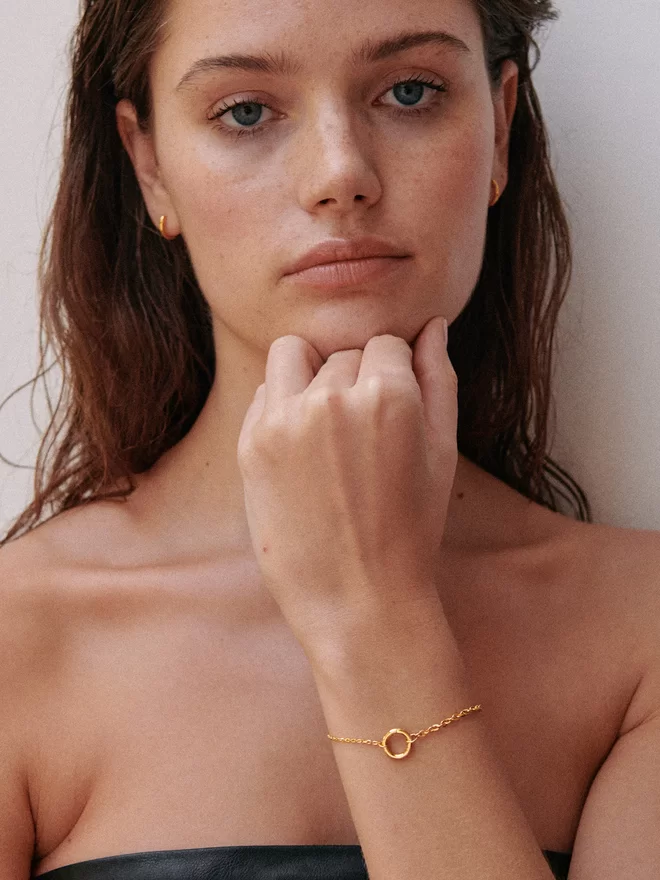 woman wearing gold bracelet