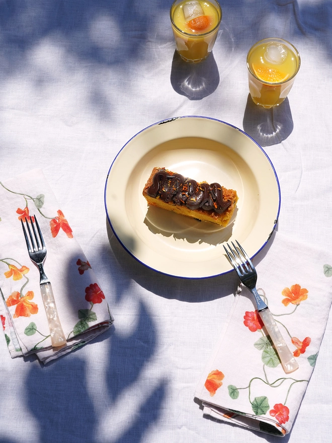 table with cake and juice linen napkins printed with nasturtiums