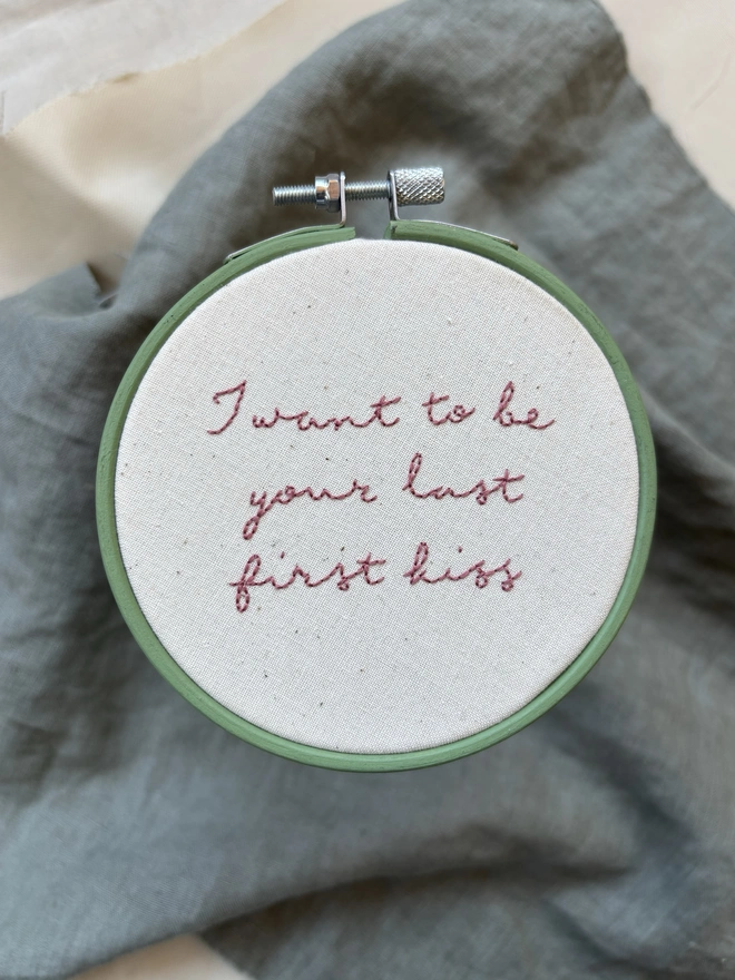 I want to be your last first kiss hand embroidered lettering in pink thread on natural calico in green hoop