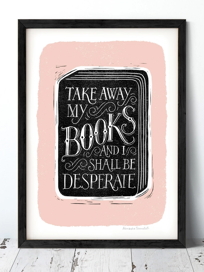book reading quote print in black and white on a pink background shown in a black frame