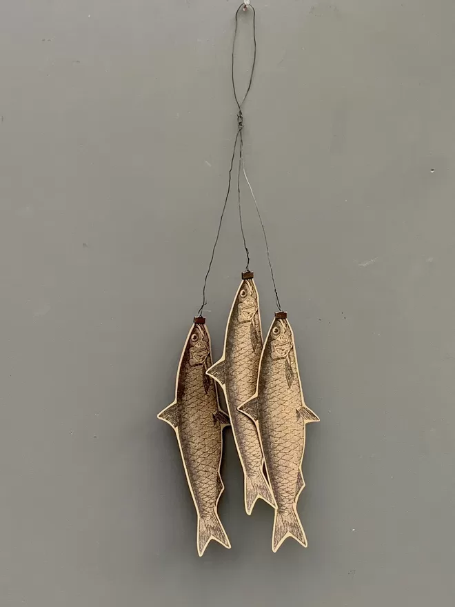 Three hanging paper cut fish