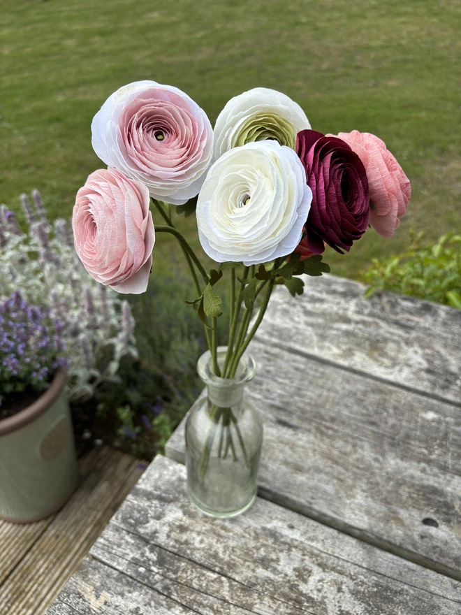 ranunculus bunch of paper flowers outside