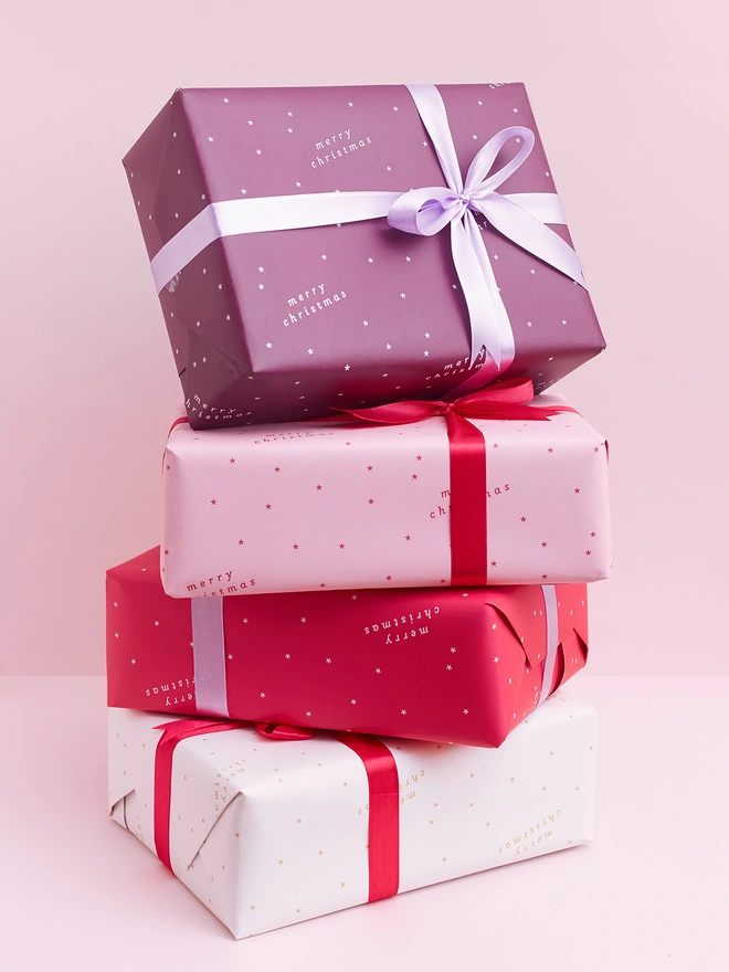 stack of presents wrapped in minimal christmas wrapping paper