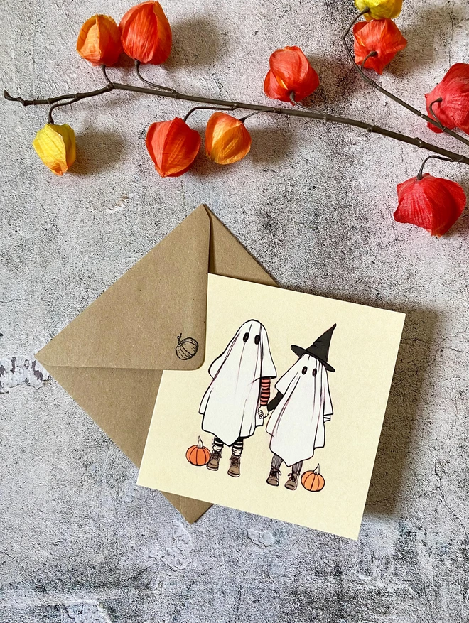 greeting card featuring a halloween image of 2 ghosts holding hands