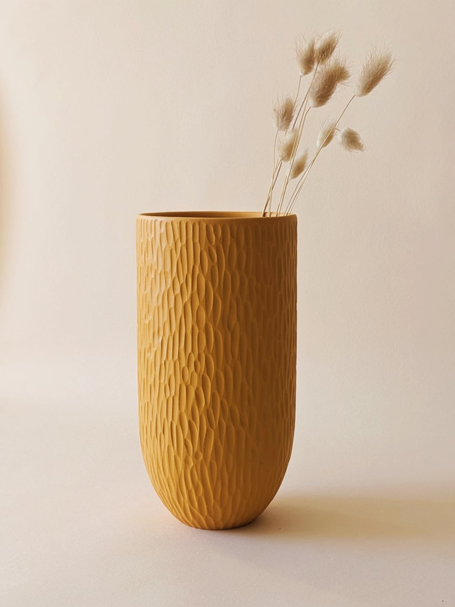 handmade textured yellow vase with dried flowers