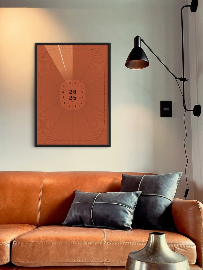 Sundial Personalised Date Poster in black frame, on whire wall above orange sofa