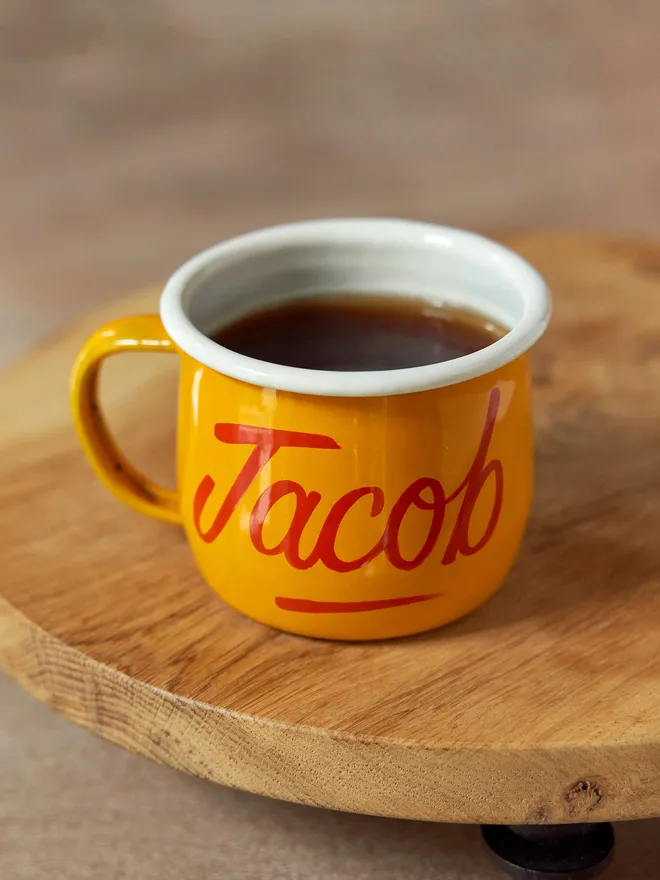 yellow mug with 'jacob' script text