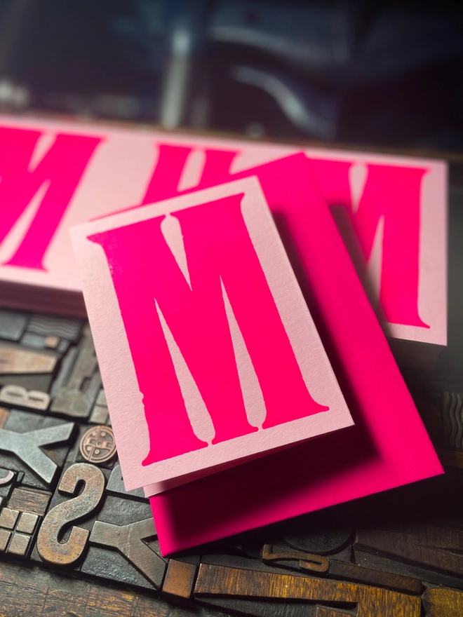 An artisan Mother’s Day concertina card printed in bold Runic Grotesque type using fluorescent pink ink on thick GF Smith Colorplan Candy Pink card, letterpress printed with a deep impression.