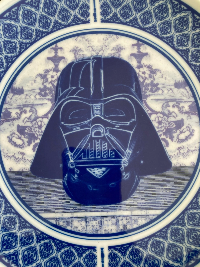 Blue and white Delft style plate featuring the head of Darth Vader in the centre