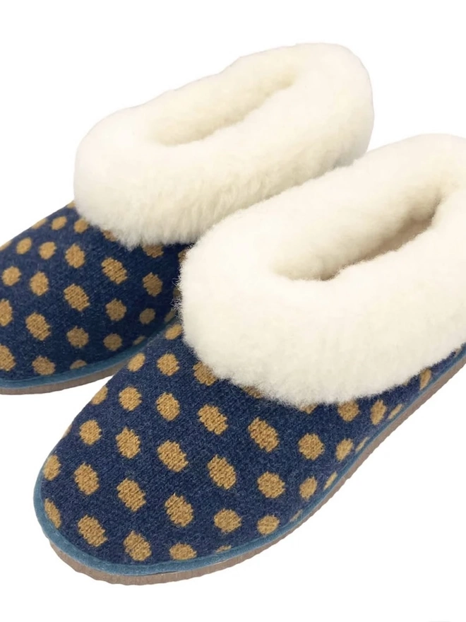 Lambswool & Sheepskin Slippers, a pair of colourful lambswool and sheepskin slippers sitting on a plain white surface. 